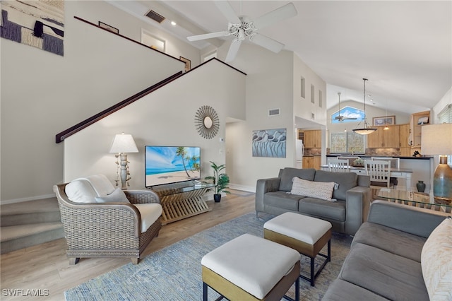 living room featuring light wood-type flooring, high vaulted ceiling, and ceiling fan