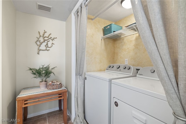 laundry area featuring tile patterned floors and washing machine and clothes dryer