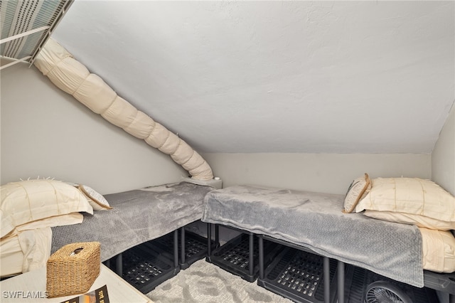 carpeted bedroom featuring lofted ceiling