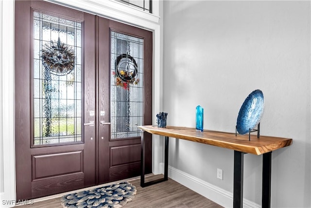 foyer entrance with light hardwood / wood-style floors and french doors