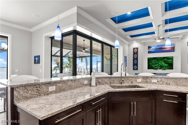 kitchen with ceiling fan, decorative light fixtures, and sink