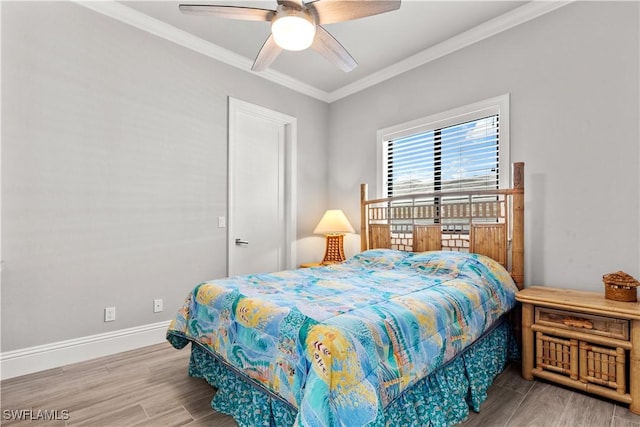 bedroom with crown molding, hardwood / wood-style floors, and ceiling fan