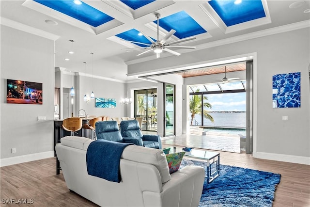 living room with coffered ceiling, ornamental molding, beamed ceiling, ceiling fan, and hardwood / wood-style floors