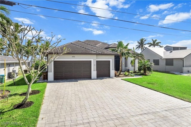 view of front of home featuring a garage and a front yard