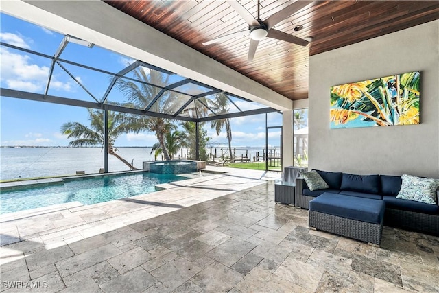 view of swimming pool with a water view, outdoor lounge area, a lanai, an in ground hot tub, and a patio