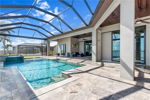 view of swimming pool featuring a lanai, a patio, ceiling fan, and an in ground hot tub