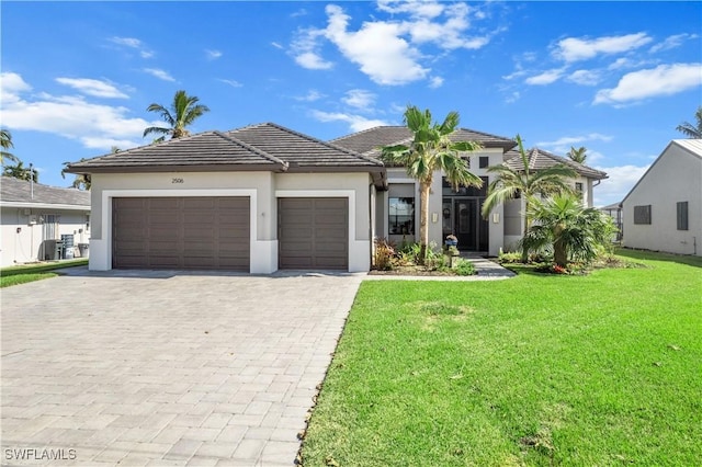 view of front of property featuring a garage and a front lawn