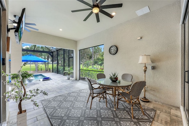 view of patio featuring ceiling fan and a lanai