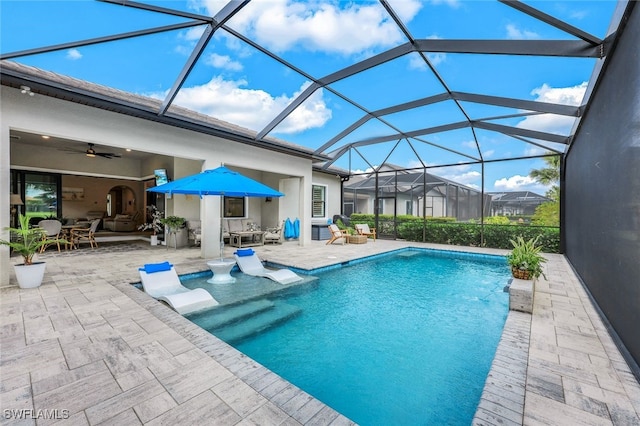 view of pool featuring ceiling fan, a patio, and a lanai