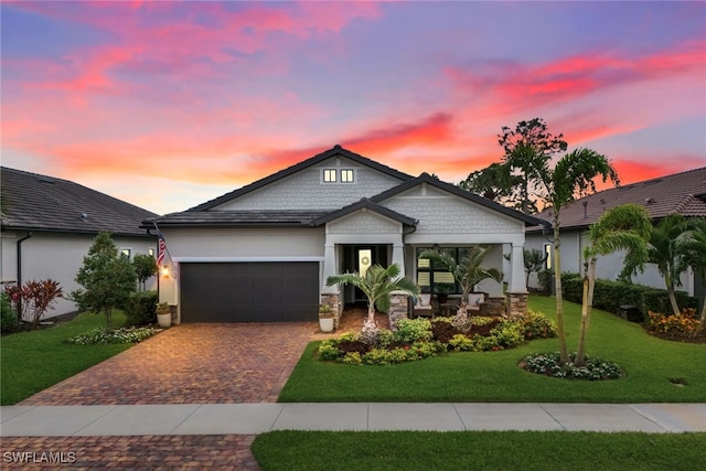 craftsman-style house with a garage and a yard