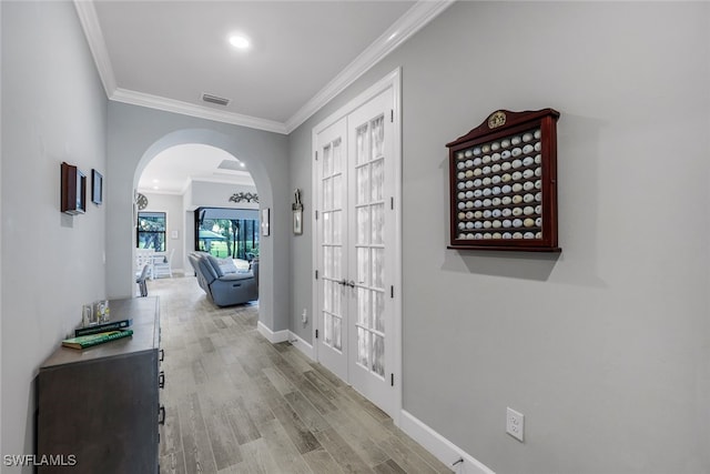 hallway with french doors, light hardwood / wood-style flooring, and crown molding