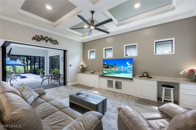 living room featuring coffered ceiling, beamed ceiling, ceiling fan, crown molding, and light wood-type flooring