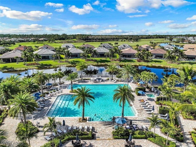 view of swimming pool with a patio area and a water view