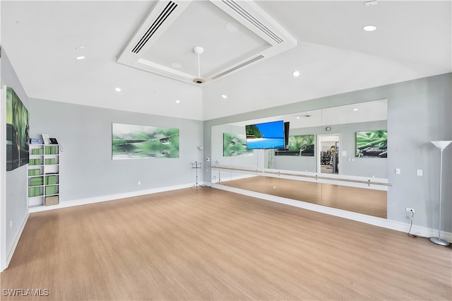 unfurnished living room with light wood-type flooring and high vaulted ceiling