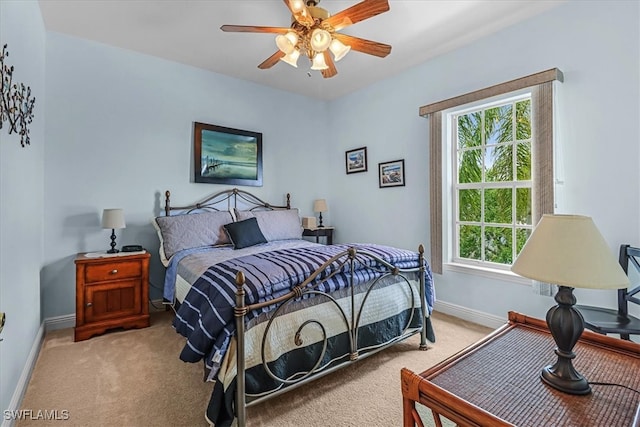 bedroom with ceiling fan, multiple windows, and light carpet