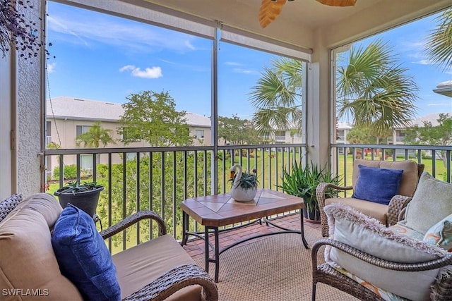 sunroom featuring ceiling fan