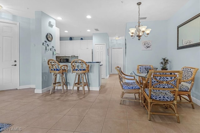 tiled dining area with an inviting chandelier