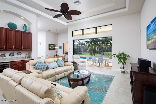 23083 Sanabria Loop, Bonita Springs, FL 34135 - living room featuring wine cooler, a towering ceiling, visible vents, ceiling fan, and a raised ceiling