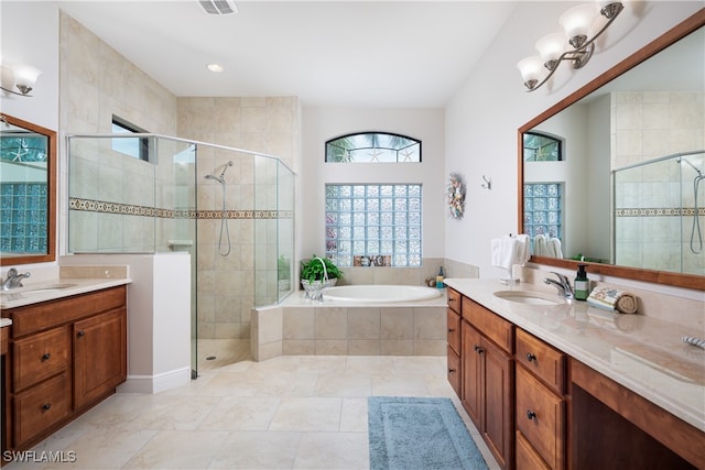 bathroom featuring vanity, tile patterned floors, and separate shower and tub