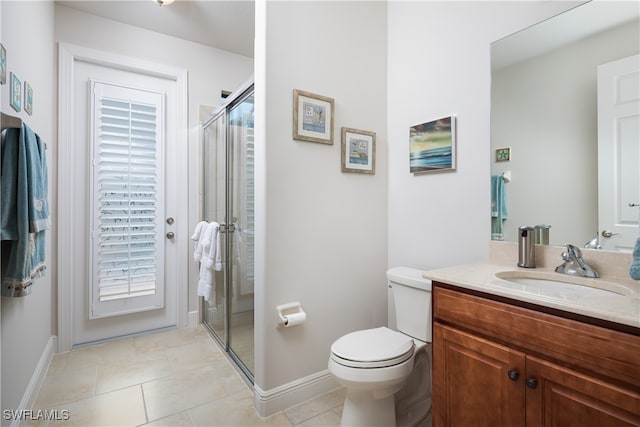 bathroom featuring vanity, tile patterned floors, toilet, and a shower with door