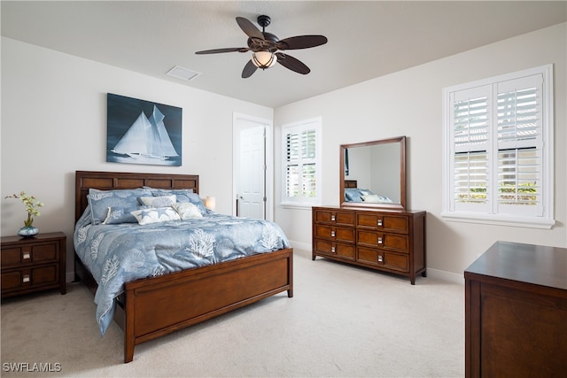 bedroom featuring light colored carpet and ceiling fan