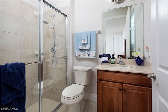 bathroom featuring a shower with shower door, vanity, and toilet