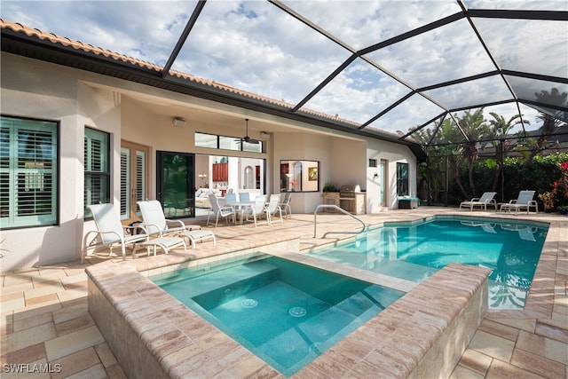 view of pool featuring ceiling fan, a patio, a lanai, and an in ground hot tub