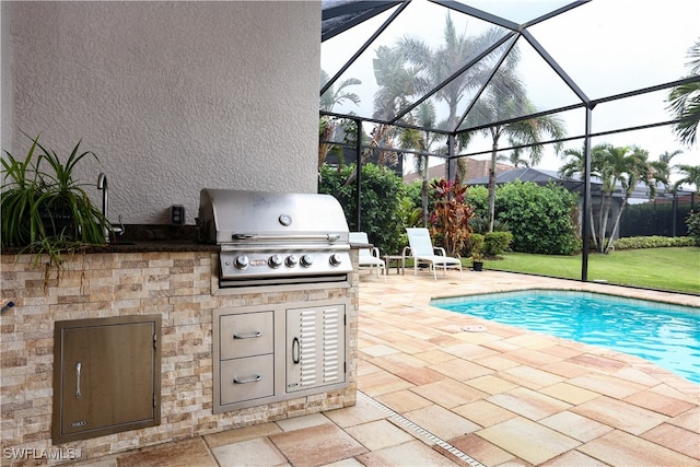 view of patio featuring exterior kitchen, glass enclosure, and grilling area