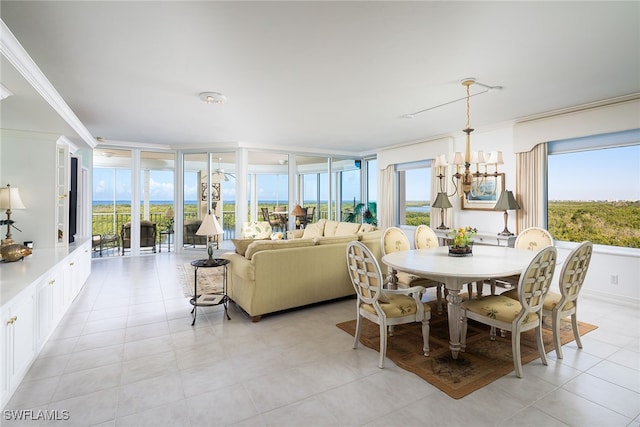 dining room featuring ornamental molding, a chandelier, plenty of natural light, and light tile patterned floors