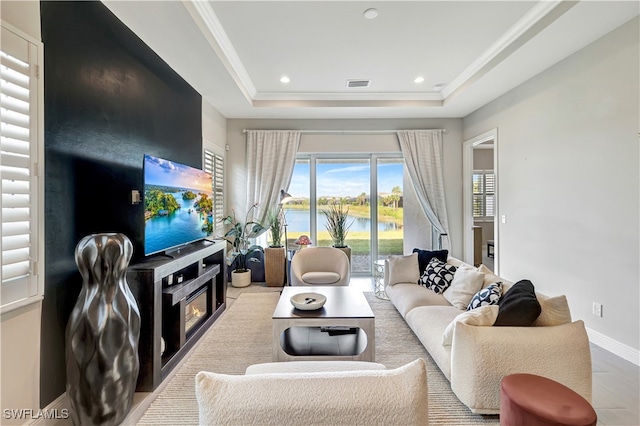 tiled living room with a raised ceiling and crown molding