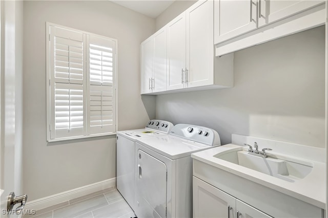 washroom featuring washer and clothes dryer, cabinets, and sink