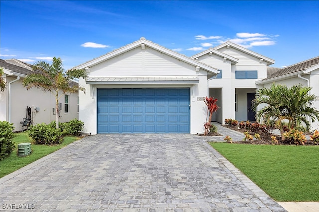 view of front facade with a front yard and a garage