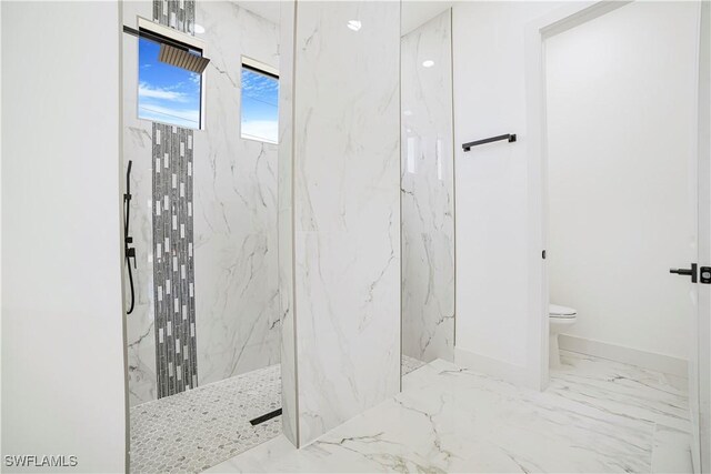 bathroom featuring toilet and a tile shower