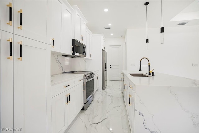 kitchen with white cabinets, sink, light stone countertops, decorative light fixtures, and stainless steel appliances