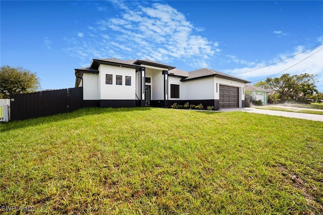 view of front of home featuring a garage and a front yard