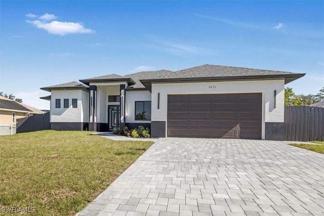 view of front of property featuring a garage and a front lawn