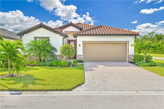 mediterranean / spanish house with a garage and a front yard