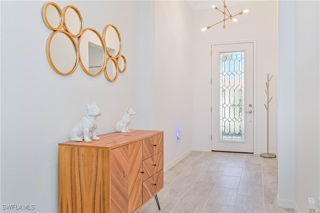 tiled entryway with an inviting chandelier