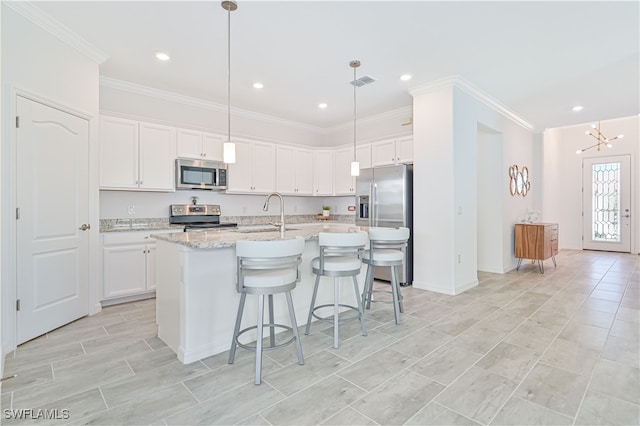 kitchen featuring white cabinetry, a center island with sink, and appliances with stainless steel finishes