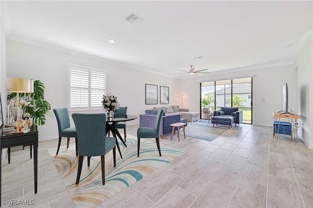 dining area with ornamental molding and ceiling fan