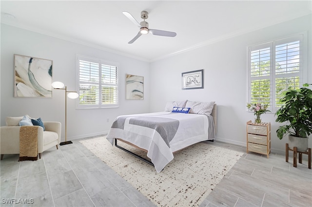 bedroom featuring ceiling fan, multiple windows, and crown molding