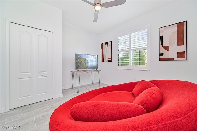 living area featuring hardwood / wood-style flooring and ceiling fan