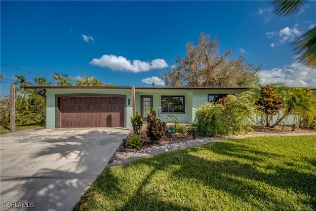 ranch-style home with a front lawn and a garage