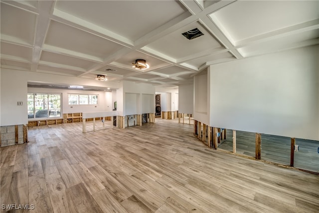 interior space featuring beamed ceiling, coffered ceiling, and light hardwood / wood-style flooring