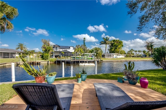 dock area with a water view and a lawn