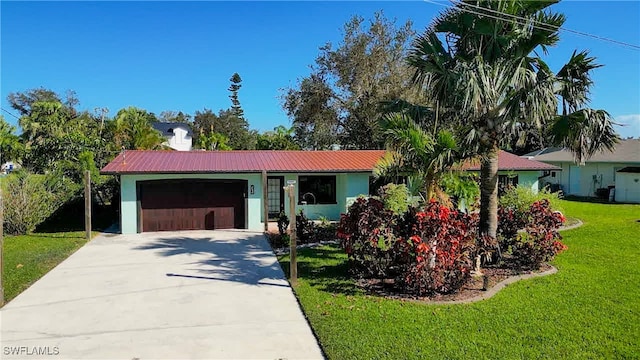 single story home featuring a front lawn and a garage