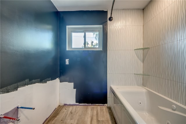 bathroom featuring a tub to relax in and hardwood / wood-style flooring