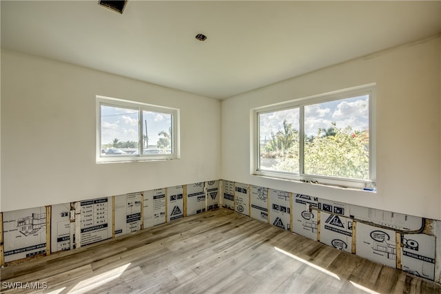 empty room with light hardwood / wood-style flooring