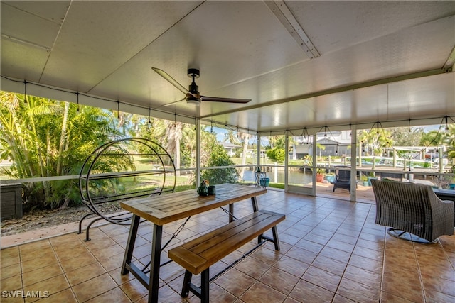 sunroom featuring ceiling fan