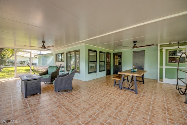 sunroom featuring ceiling fan